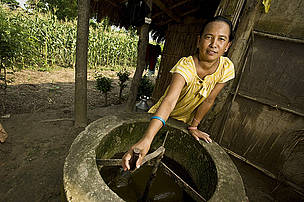 A woman standing with her communities biogas plant, Chitwan National Park, Nepal. © Simon de TREY-WHITE / WWF-UK Woman, Bio gas village, Chitwan, Nepal.