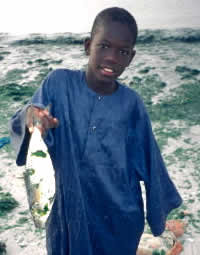 Child holding fish, M'Bour, Senegal © WWF / Jo Benn Child holding fish, M'Bour, Senegal