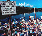 Trash dumped in mangrove forest, Hol Chan Marine Reserve, Belize.
