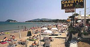 Bar sign using Loggerhead turtle (Caretta caretta) name with tourists sunbathing on beach in front, ... / ©: WWF / Michel GUNTHER Bar sign using Loggerhead turtle (<i>Caretta caretta</i>) name with tourists sunbathing ... / ©: WWF / Michel GUNTHER