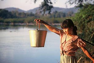 Tribal girl collects water in the evening from the Serepok River in a poor commune in Vietnam's Central Highlands. © Elizabeth Kemf / WWF Tribal girl collects water in the evening from the Serepok River in a poor commune in Vietnam's Central Highlands where thousands of poor villagers have access to sanitation.