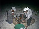 Johanny Cruz (L) helps Pelagio Paulino to tag Adamanay.